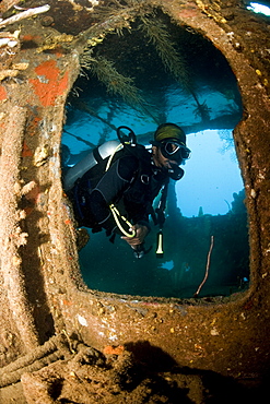 Diver inside the wreck of the Lesleen M freighter, sunk as an artificial reef in 1985 in Anse Cochon Bay, St. Lucia, West Indies, Caribbean, Central America