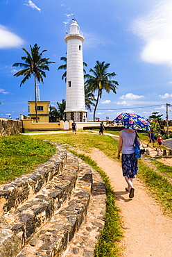 Tourist visiting Galle lighthouse in the Old Town of Galle, UNESCO World Heritage Site, Sri Lanka, Asia 