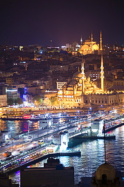 New Mosque (Yeni Cami) and Galata Bridge across Golden Horn at night seen from Galata Tower, Istanbul, Turkey, Europe