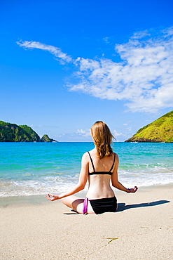 Woman meditating at Mawun Beach, South Lombok, Indonesia, Southeast Asia, Asia