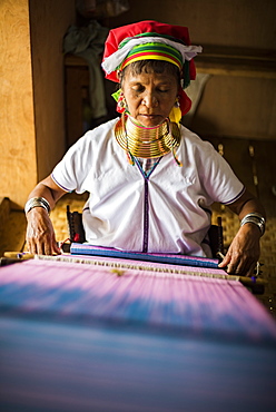 Long necked woman from Padaung tribe weaving at Inle Lake, Shan State, Myanmar (Burma), Asia