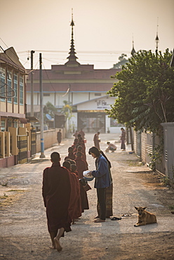 Young novice monks collecting alms at sunset in Pindaya, Shan State, Myanmar (Burma)