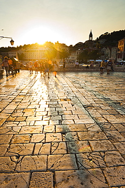 Tourists in St. Stephens Square at sunset, Hvar Town, Hvar Island, Dalmatian Coast, Croatia, Europe