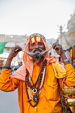 Portrait of Sadhu in orange robes in Pushkar, Rajasthan, India, Asia