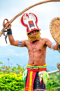 Caci man performing a traditional whip dance with bamboo shield and leather whip, western Flores, Indonesia, Southeast Asia, Asia