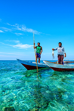 Bajau Fishermen holding an octopus, Togian Islands, Indonesia, Southeast Asia, Asia