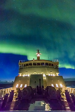 Aurora borealis (Northern Lights) dance above the Lindblad Expeditions ship National Geographic Explorer in Hudson Strait, Nunavut, Canada, North America