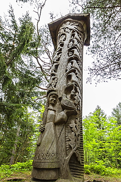 Wood carvings from traditional folklore at The Hill of Witches on the Dano River at the northern tip of the Curonian Spit, Klaipedia, Lithuania, Europe