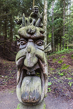 Wood carvings from traditional folklore at The Hill of Witches on the Dano River at the northern tip of the Curonian Spit, Klaipedia, Lithuania, Europe