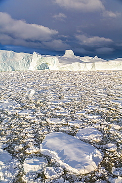 Huge iceberg amongst sea ice near Petermann Island, western side of the Antarctic Peninsula, Southern Ocean, Polar Regions