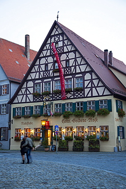 Hotel Goldene Rose in the old town at dusk, Dinkelsbuehl, Franconia, Bavaria, Germany