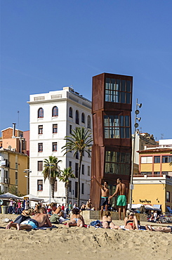 Girls sunbathing on Barceloneta beach, Sculpture by Rebecca Horn, Barcelona, Spain