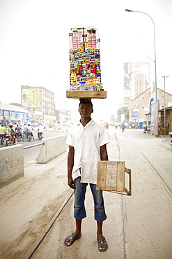 Merchant carrying a mobile kiosk, Ganxi, Cotonou, Benin