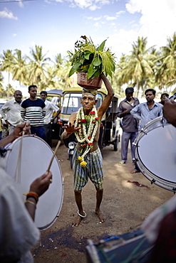 Pilgrim carrying holy water on his head while dancing, Mysore, Karnataka, India