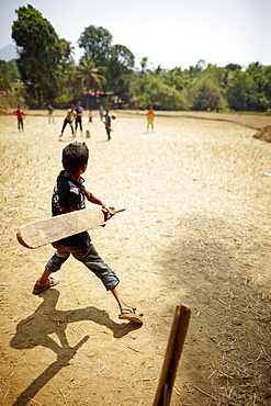 Boys playing cricket, Kakkinje, Karnataka, India