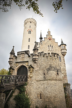 View of Lichtenstein castle with draw-bridge in autumn, Swabian Alp, Baden-Wuerttemberg, Germany