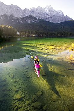 Kayaker paddling on the Eibsee below Zuspitze, Grainau, Bavaria, Germany