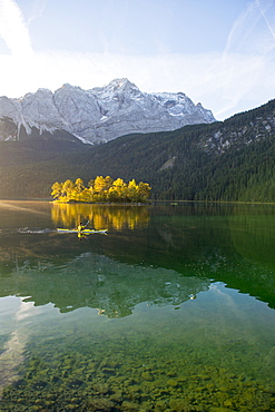 Kayaker paddling on the Eibsee below Zuspitze, Grainau, Bavaria, Germany