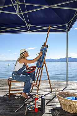 Young Woman with artist's easel, Fraueninsel, Chiemsee, Bavaria, Germany