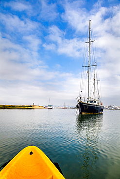 Kayak tour and sailing boat in the lagoon, Parque Natural da Ria Formosa, Faro, Algarve, Portugal