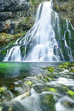 Waterfall cascading in green pond, Gollinger Wasserfall, Golling, Berchtesgaden range, Salzburg, Austria