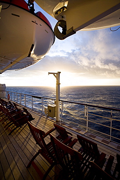 Promenade deck with deck chairs at sunset, Cruise liner Queen Mary 2, Transatlantic, Atlantic ocean