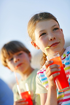 Girl and boy with fruit Juice, Formentera, Balearic Islands, Spain