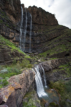 Waterfall Cascada el Escobar under clouded sky, El Risco valley, Parque Natural de Tamadaba, Gran Canaria, Canary Islands, Spain, Europe