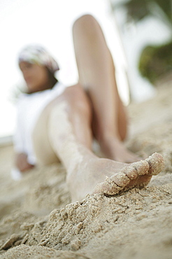 Young woman lying on the beach