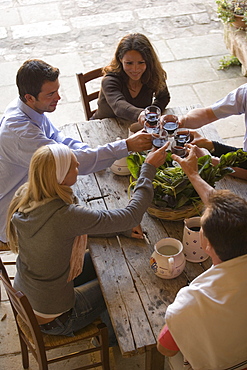 Group of people having dinner together on terrace, Apulia, Italy