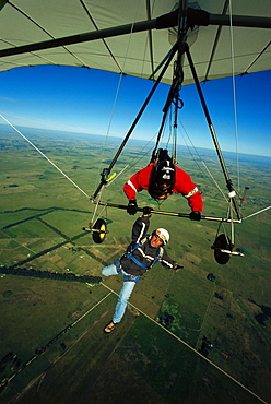 Man hanging below of a hang glider