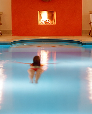 Woman swimming in a pool, chimney in background, Hotel Neuklostersee, Nakenstorf, Mecklenburg-Western Pomerania, Germeny, MR, PR