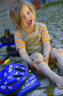 Girl showing an adhesive bandage on her Knee