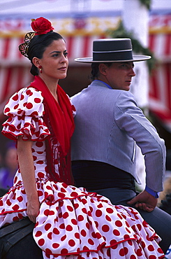 Middle-aged couple in traditional costumes on horseback, Romeria de San Isidro, Nerja, Costa del Sol, Malaga province, Andalusia, Spain, Europe