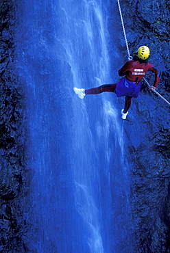 Person canyoning at Gobert Waterfall, Cilaos, La Réunion, Indian Ocean