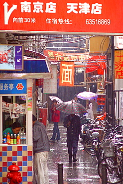 People in the city in the rain, Shanghai, China, Asia