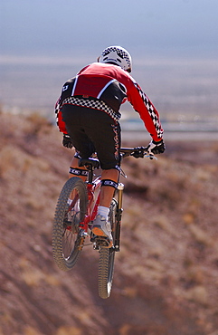 Man on a mountain bike doing a jump, Gooseberry Trail, Zion National Park, Springdale, Utah, USA