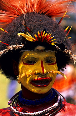 Local man with yellow painted face, Wigman, Portrait, Sing Sing festival, Mt Hagen, Eastern Highlands, Papua New Guinea, Melanesia