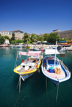 Boats, harbour and city wall under blue sky, Antalya, Turkey, Europe