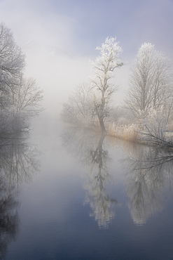 Winter idyll at the Kochelsee spout of the Loisach, Bavaria, Germany.