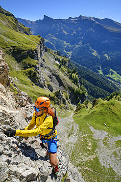 Woman climbs on the Gemmi adventure via ferrata, Gemmi, Bernese Alps, Valais, Switzerland