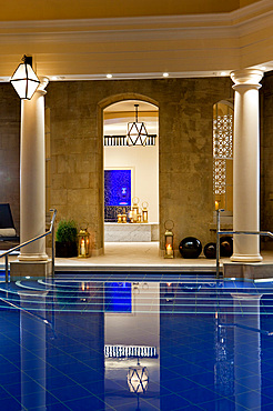 Evening shot of pool room with a view through open door to threatment rooms, Bath, United Kingdom