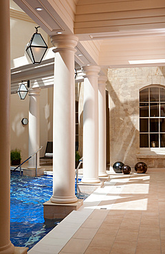 Daylight shot of streaks of light on columns inside an interior poolroom, Bath, United Kingdom