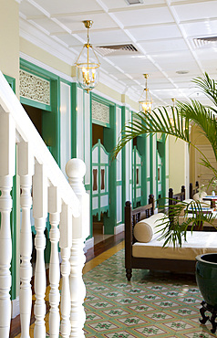 Interior view of a spa, treatment room in faded green colors and decorative floor tiles. Malacca, Malaysia.