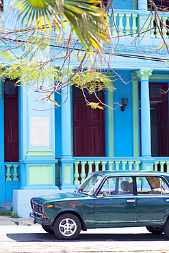 Classics car in front of a blue building in Pinar del Rio, Cuba