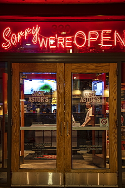 Illuminated "Sorry We're Open" neon sign at Jack Astor's Bar