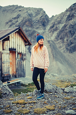 Woman stands at the Totalphütte in the Rätikon above the Lünersee, Vorarlberg, Austria, Europe