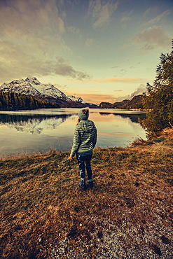 Woman at sunrise on Lake Sils, Engadin, Grisons, Switzerland, Europe