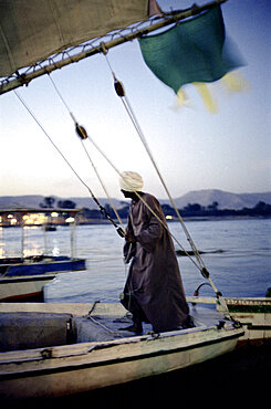 man on a sailing boot, luxor, aswan, egypt