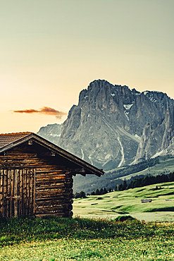 Hut at sunrise on the Seiser Alm in South Tyrol, Italy, Europe;